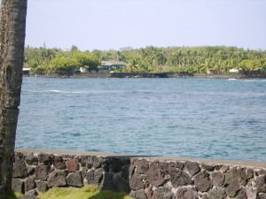 Photo of the entrance to Champagne Ponds taken from across the ocean at Dragon's Point